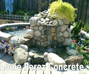 Pond Waterfall Surrounded by Flower Plants